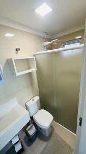 a bathroom with a white toilet and a shower at Bouganville Guest House BC in Balneário Camboriú +40 photos