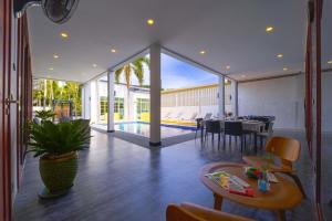 a living room with a table and a dining room at Beautiful 4-Bedroom Pool Villa - BL9 in Hua Hin