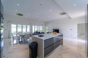 a kitchen and dining room with a table and chairs at Nice 3BR with Golf Course View - BMG3 in Hua Hin