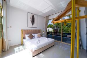 a bedroom with a bed and a balcony at Beautiful 4-Bedroom Pool Villa - BL9 in Hua Hin +52 photos