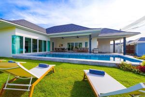 a villa with a swimming pool and a house at Modern 3 Bedroom Villa - AS1 in Hua Hin