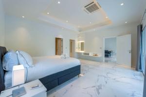 a bedroom with a bed and a marble floor at Nice 3BR with Golf Course View - BMG3 in Hua Hin +45 photos