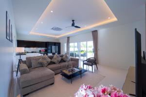 a living room with a couch and a table at Modern 3 Bedroom Villa - AS1 in Hua Hin