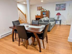 a dining room table and chairs in a living room at The Convenient Suite in Charlottetown