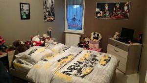 a bedroom with a bed with stuffed animals on it at Appartement chaleureux in Luxeuil-les-Bains