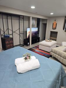 a large room with two beds and a flat screen tv at The Nook Suite in Hackensack