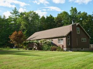 a house with a grass yard in front of it at Visit Chill House 15 miles from Windham Hot Tub and Ping Pong in Cairo