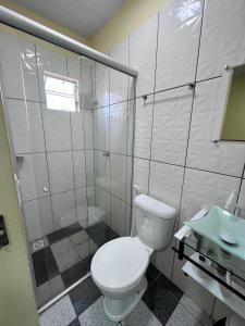 a bathroom with a toilet and a shower and a sink at Saymon Hotel in Portel