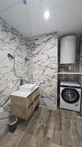 a bathroom with a sink and a stove at Appartement T2 moderne 2 à 4 personnes in Lucciana +16 photos