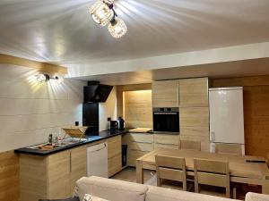a kitchen with a table and a dining room at La Jassette 7 in Saint-Pierre-dels-Forcats