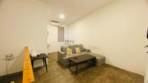 a living room with a couch and a table at Wong village 106 in Tumbak Bayuh