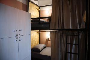 a small room with two bunk beds and a mirror at Shkodra Hostel & Day Tours in Shkodër +100 photos