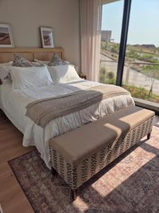 a bedroom with a large bed with a large window at Modern Luxury Beach Villa in Ballito +36 photos