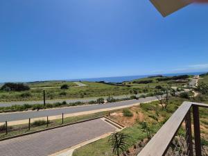 a view from the balcony of a house with a road at Modern Luxury Beach Villa in Ballito