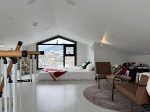a bedroom with a bed and a large window at #2 NEW open 신축건물 엘리베이터 짐보관 홍대입구역 도보5분 마포구 쇼핑 in Seoul