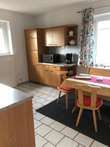 a kitchen with a table and chairs in a room at Ferienwohnung Dresden West in Dresden
