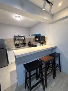 a kitchen with two stools sitting at a counter at Casa Tres - home in San Mateo 