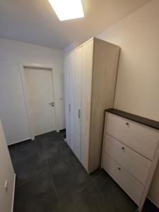 an empty room with a cabinet and a door at Stan na dan Brčko Zaga Profesora Esada Pitića 7 in Brčko