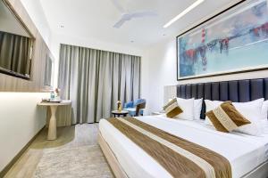 a bedroom with a large bed in a room at OPO Premium - Free Pickup delhi Airport in New Delhi