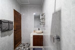 a bathroom with a sink and a mirror at Doa Ubud Villa in Ubud +17 photos