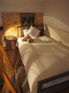 a bed with a towel on it in a bedroom at Sakuranbo - Hostel in Budapest