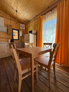 a wooden dining table and chairs in a kitchen at Parpi Riverside in Pʼarpi