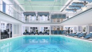 a large swimming pool in a house with a ceiling at Le Blanc Heritage Hotel in Yen Bai