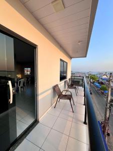 a balcony with chairs and a view of the ocean at Saymon Hotel in Portel