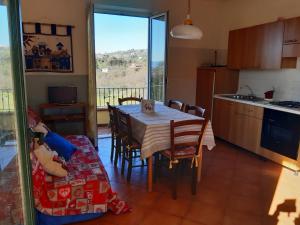 a kitchen and dining room with a table and a couch at cascina dei peri in Castelnuovo Magra +65 photos
