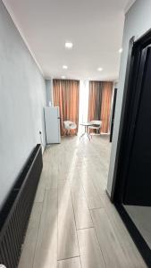 an empty room with a table and chairs in a building at Cozy appartment in Tbilisi City
