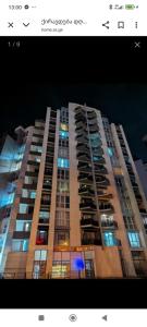 a large apartment building at night with lights on at Cozy appartment in Tbilisi City