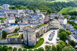 an aerial view of an old castle in a town at Maison Onze calme en bord de Rance in Plouër-sur-Rance