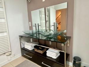 a bathroom with a glass sink and a mirror at Maison Onze calme en bord de Rance in Plouër-sur-Rance +42 photos