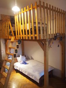 a bunk bed and a bed in a room at Sakuranbo - Hostel in Budapest
