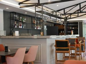 a bar in a restaurant with chairs and tables at EMAN TERMAL HOTEL in Ilıcalı