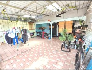 a garage with a room filled with clothes at 欢唱名宿 in Kluang