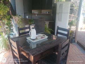 a wooden table with a vase on top of it at Flat no Garden III in Rondonópolis