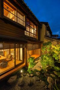 a house with a garden in front of it at ROKUSYO Kanazawa in Kanazawa