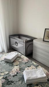 a bedroom with a bed and a dresser and a rug at Garden Lake Apartment in Peschiera del Garda