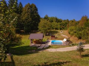 a house with a swimming pool and a gazebo at Holiday Home Elizabeta in Slunj