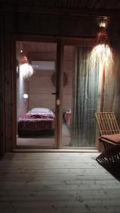 a view of a bedroom with a bed through a window at Garden12 Outdoor & More in Douz