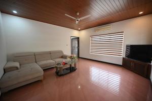 a living room with a couch and a flat screen tv at Tinton Adventure Resort in Golikatte
