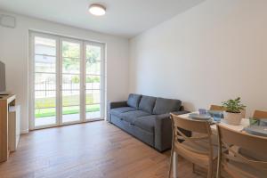 a living room with a couch and a table at Spina Verde Palazzo in Cavallasca