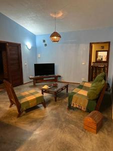 a living room with a couch and a table at Chalezinho da Mari in Fortim