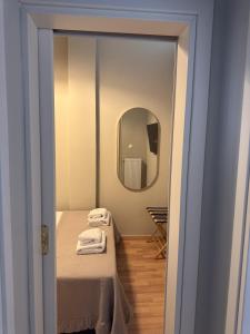 a small room with a bed and a mirror at Aristotelous View Suites - Smooth Living in Thessaloniki +21 photos