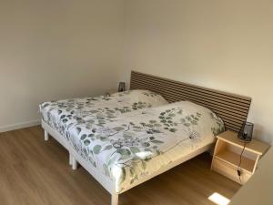 a small bedroom with a bed with a white comforter at Maison au cœur du pays de Rabelais in Lerné