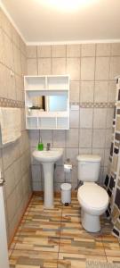 a bathroom with a toilet and a sink at Casa Turismo Freirina in Freirina +11 photos