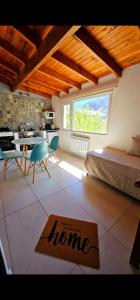 a bedroom with a bed and a table and a kitchen at Ekos de Saint Exupery in El Chalten