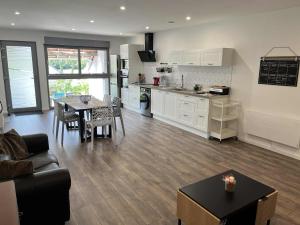 a kitchen and living room with a table and a couch at Grange de Courbey in Chambornay-lès-Pin