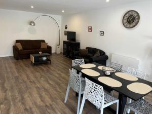 a living room with a table and chairs and a couch at Grange de Courbey in Chambornay-lès-Pin